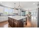 Open concept kitchen features a large island, granite countertops, and seamless access to the dining and living areas at 11584 Pine Canyon Ln, Parker, CO 80138