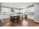 Bright kitchen boasts white cabinets, stainless steel appliances, and a large center island with bar seating at 11584 Pine Canyon Ln, Parker, CO 80138