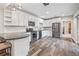 Modern kitchen boasts white cabinets, stainless steel appliances, and wood-look flooring with an adjacent dining area at 11584 Pine Canyon Ln, Parker, CO 80138