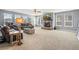 Spacious living room with a cozy stone fireplace and multiple windows for natural light at 11584 Pine Canyon Ln, Parker, CO 80138