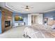 Stylish main bedroom boasts a fireplace, TV, and ample closet space at 11584 Pine Canyon Ln, Parker, CO 80138