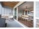 Relaxing outdoor patio with hanging chair, grill, and view into the dining area at 11584 Pine Canyon Ln, Parker, CO 80138