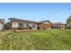 Spacious backyard with a deck and mature trees at 865 S 8Th Ave, Brighton, CO 80601