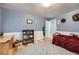 This room has stylish, neutral carpet and access to an adjacent room and a large window at 865 S 8Th Ave, Brighton, CO 80601