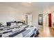 Cozy bedroom features a bed, wood floor, and access to the en-suite bathroom at 865 S 8Th Ave, Brighton, CO 80601