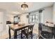 Cozy dining area featuring a modern chandelier and an open view of the living space at 865 S 8Th Ave, Brighton, CO 80601