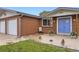 Welcoming front porch with a blue door, brick facade, and a cozy seating area at 865 S 8Th Ave, Brighton, CO 80601
