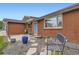 Inviting front entrance with a blue door, brick facade, and decorative landscaping at 865 S 8Th Ave, Brighton, CO 80601