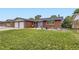 Charming red brick home with a well-maintained front yard and blue door at 865 S 8Th Ave, Brighton, CO 80601