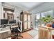 Bright home office with an ornate armoire, desk, and access to an outdoor space at 865 S 8Th Ave, Brighton, CO 80601