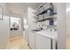Bright laundry room with modern appliances and shelving for storage at 865 S 8Th Ave, Brighton, CO 80601