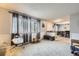 Bright living room with large windows, neutral carpet, and a connected dining area at 865 S 8Th Ave, Brighton, CO 80601