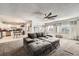 Open-concept living room with a cozy sectional sofa, carpeted floor and natural light from the kitchen at 865 S 8Th Ave, Brighton, CO 80601