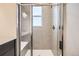 Stylish shower with glass door, tiled walls, and built-in bench at 9654 Browns Peak Cir, Littleton, CO 80125