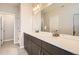 Bathroom featuring a double sink vanity with contemporary fixtures and a large mirror at 9654 Browns Peak Cir, Littleton, CO 80125