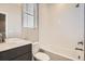 Modern bathroom with a white tiled shower-tub, and a dark vanity with a white countertop at 9654 Browns Peak Cir, Littleton, CO 80125