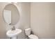 Powder room featuring a modern pedestal sink and toilet at 9654 Browns Peak Cir, Littleton, CO 80125