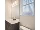 Bathroom featuring a modern vanity with a large mirror, bright lighting and a window at 9654 Browns Peak Cir, Littleton, CO 80125