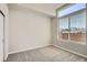 Bright bedroom featuring plush gray carpeting and a large window offering ample natural light at 9654 Browns Peak Cir, Littleton, CO 80125