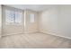 Neutral bedroom with carpeted floors and dual windows for ample natural light at 9654 Browns Peak Cir, Littleton, CO 80125