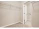 Walk-in closet with wire shelving, adjoining a laundry area at 9654 Browns Peak Cir, Littleton, CO 80125