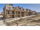 Exterior view showcasing multiple townhomes with stone accents and balconies at 9654 Browns Peak Cir, Littleton, CO 80125