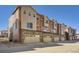 Townhome exterior featuring stone accents, attached garages and neutral siding at 9654 Browns Peak Cir, Littleton, CO 80125