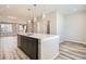 Kitchen island open to living area, complete with stainless dishwasher at 9654 Browns Peak Cir, Littleton, CO 80125