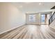 Bright living room featuring wood floors, large window, and sliding door access to the outdoors at 9654 Browns Peak Cir, Littleton, CO 80125