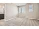 Bright bedroom with large windows, carpeted floors, and a view into the ensuite bathroom at 9654 Browns Peak Cir, Littleton, CO 80125