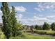 Scenic walking path with mature trees, lush landscaping, and views of the neighborhood at 9654 Browns Peak Cir, Littleton, CO 80125