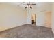 Bright bedroom featuring a ceiling fan and en-suite bathroom access at 7851 S Quatar Ct, Aurora, CO 80016