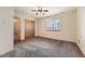 Bright bedroom with carpet flooring, double door closet and ceiling fan at 7851 S Quatar Ct, Aurora, CO 80016