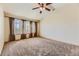 Spacious carpeted bedroom with large windows and ceiling fan at 7851 S Quatar Ct, Aurora, CO 80016