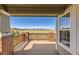 Deck overlooking scenic landscape with brick pillars and wooden railing at 7851 S Quatar Ct, Aurora, CO 80016