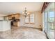 Dining area with tile flooring, chandelier, and sliding door to deck at 7851 S Quatar Ct, Aurora, CO 80016