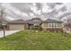 Brick and shingle ranch home with attached two-car garage and landscaped lawn at 7851 S Quatar Ct, Aurora, CO 80016