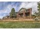 Back exterior of home with deck and fenced yard at 7851 S Quatar Ct, Aurora, CO 80016