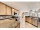 Kitchen with granite countertops, stainless steel appliances, and wood cabinets at 7851 S Quatar Ct, Aurora, CO 80016