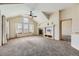 Spacious living room with vaulted ceiling, fireplace, and carpeting at 7851 S Quatar Ct, Aurora, CO 80016