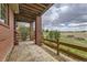 Covered patio with brick pillars and view of open space at 7851 S Quatar Ct, Aurora, CO 80016