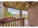 Covered patio with brick pillars and view of open space at 7851 S Quatar Ct, Aurora, CO 80016