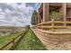 Landscaped yard with retaining wall and wooden fence at 7851 S Quatar Ct, Aurora, CO 80016