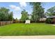 Spacious backyard with lush green grass, a shed, and a wooden fence at 2955 Poplar St, Denver, CO 80207