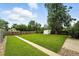 This expansive backyard features well-maintained grass, a shed, and a secure wooden fence at 2955 Poplar St, Denver, CO 80207