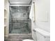 Sleek bathroom with glass shower enclosure, gray tile, and modern design at 2955 Poplar St, Denver, CO 80207