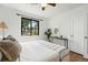 Bedroom with hardwood floors, large window, and neutral décor, perfect for relaxation and comfort at 2955 Poplar St, Denver, CO 80207