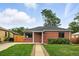 Traditional brick home with a well-manicured lawn and classic design elements at 2955 Poplar St, Denver, CO 80207
