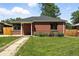 Charming brick home with a well-maintained lawn and classic architectural details at 2955 Poplar St, Denver, CO 80207