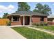 Charming brick home with a well-maintained front yard and a welcoming entrance with white columns at 2955 Poplar St, Denver, CO 80207